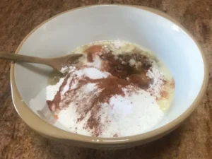 Carrot cake ingredients being combined in a mixing bowl