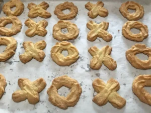 Freshly baked Spritzgebäck cookies on baking tray