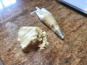 Spritzgebäck cookie dough in piping bag on countertop