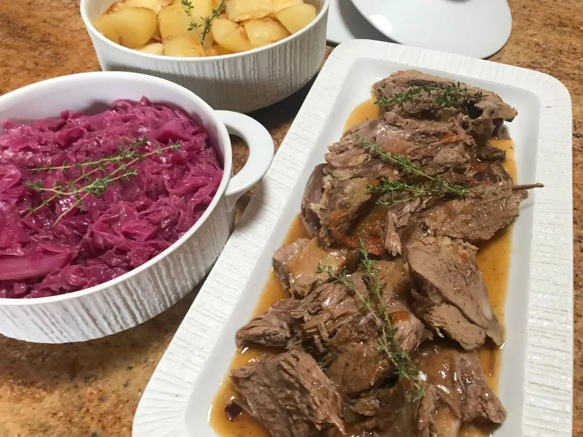 Leg of lamb served with red cabbage and roast potatoes