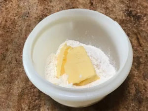 Mixing streusel crumble for plum cake topping