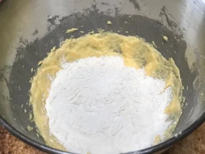 Adding flour to plum cake batter for German plum cake
