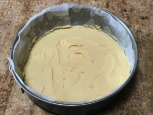 Plum cake batter spread in springform pan