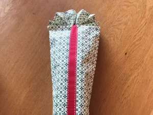 Olive oil bottle wrapped as a gift with ribbon