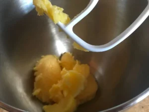Chilled browned butter being beaten until creamy
