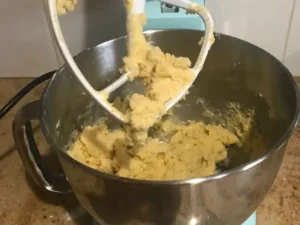Pecan Balls cookie dough being mixed after adding flour.
