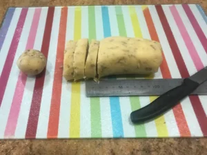 Pecan Balls dough log being sliced